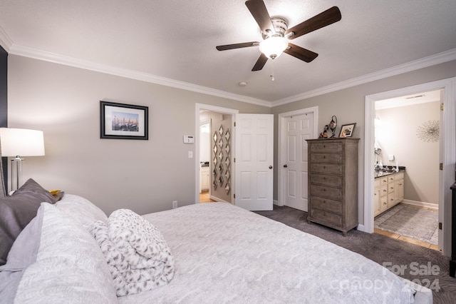 bedroom featuring crown molding, connected bathroom, and dark carpet