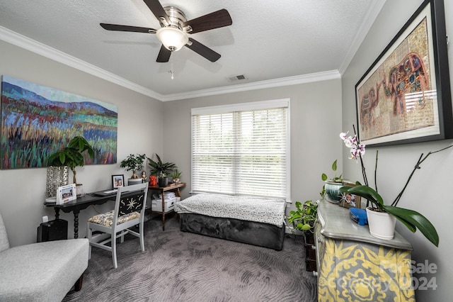 carpeted home office featuring ornamental molding, ceiling fan, and a textured ceiling