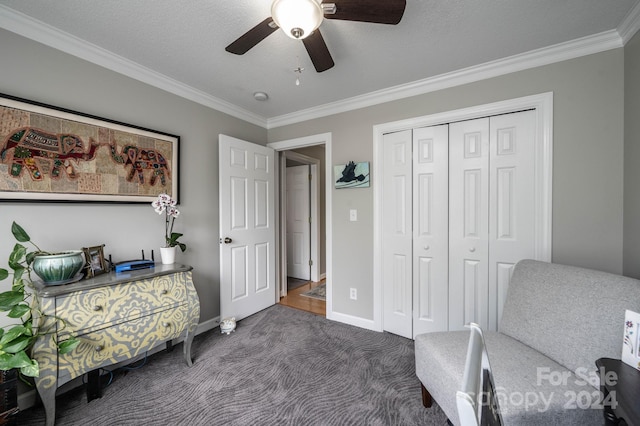 sitting room featuring crown molding, ceiling fan, and dark colored carpet