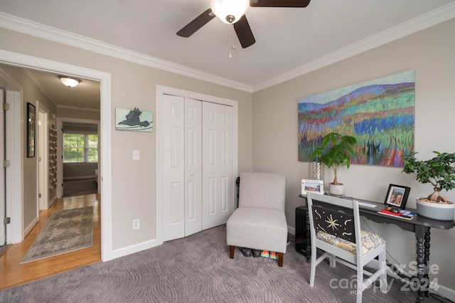 sitting room with crown molding, carpet, and ceiling fan