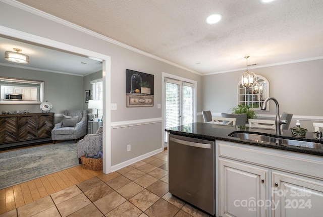 kitchen featuring appliances with stainless steel finishes, sink, white cabinets, hanging light fixtures, and ornamental molding