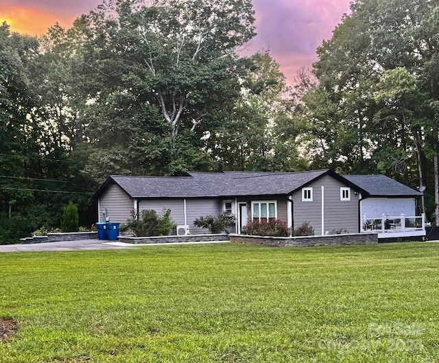 ranch-style house with a lawn