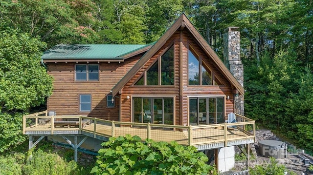 rear view of house featuring a wooden deck