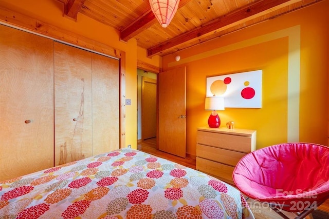 bedroom featuring wooden ceiling, a closet, and beamed ceiling