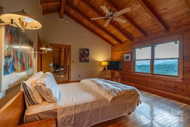 bedroom featuring high vaulted ceiling, wood walls, beamed ceiling, hardwood / wood-style flooring, and wood ceiling