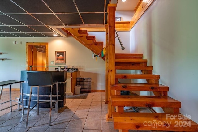 stairs featuring tile patterned flooring