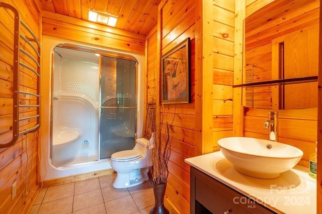 bathroom featuring tile patterned flooring, vanity, toilet, a shower with door, and wooden ceiling