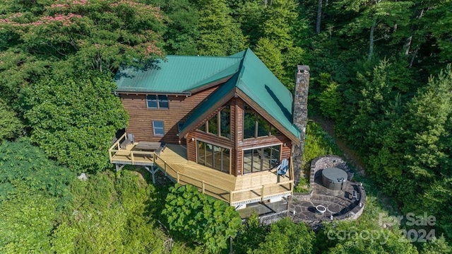 rear view of property featuring a wooden deck