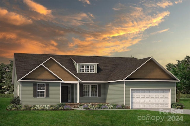 view of front of home with a garage, a lawn, and driveway