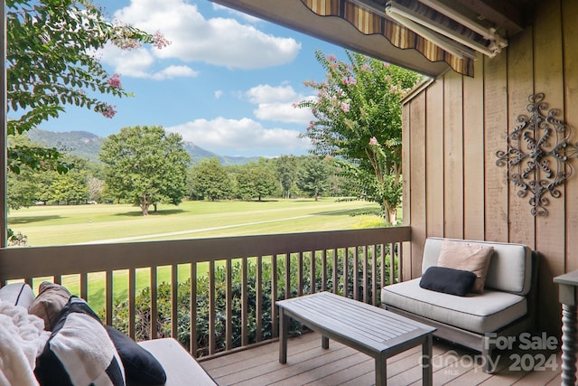 deck featuring a lawn and a mountain view