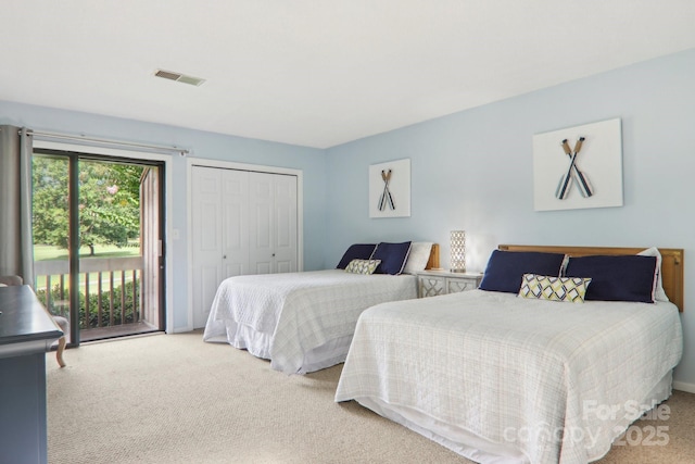 carpeted bedroom with access to exterior and a closet