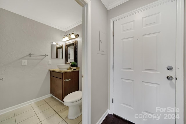 bathroom with tile patterned flooring, vanity, toilet, and ornamental molding