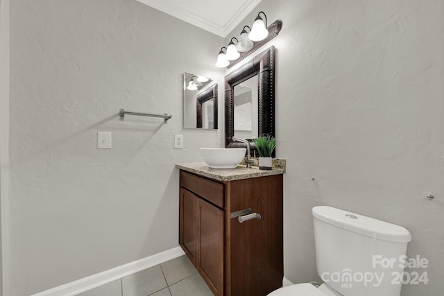 bathroom featuring tile patterned floors, crown molding, vanity, and toilet