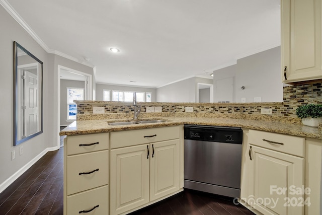 kitchen with tasteful backsplash, dark hardwood / wood-style flooring, cream cabinets, and dishwasher