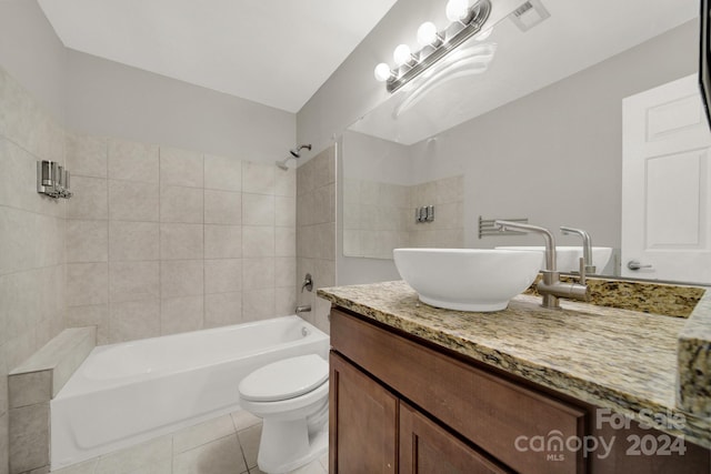 full bathroom with tile patterned flooring, vanity, toilet, and tiled shower / bath combo