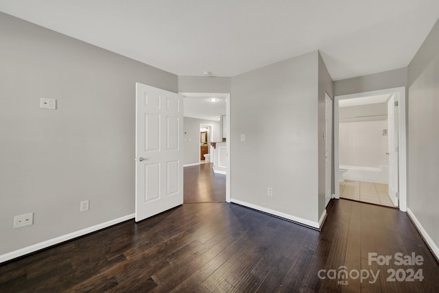 unfurnished room featuring dark wood-type flooring