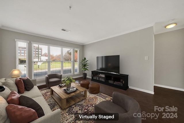 living room with dark hardwood / wood-style flooring and crown molding