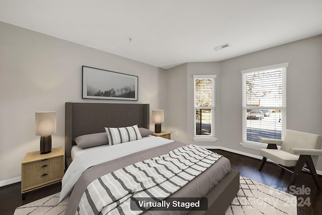 bedroom with dark hardwood / wood-style floors