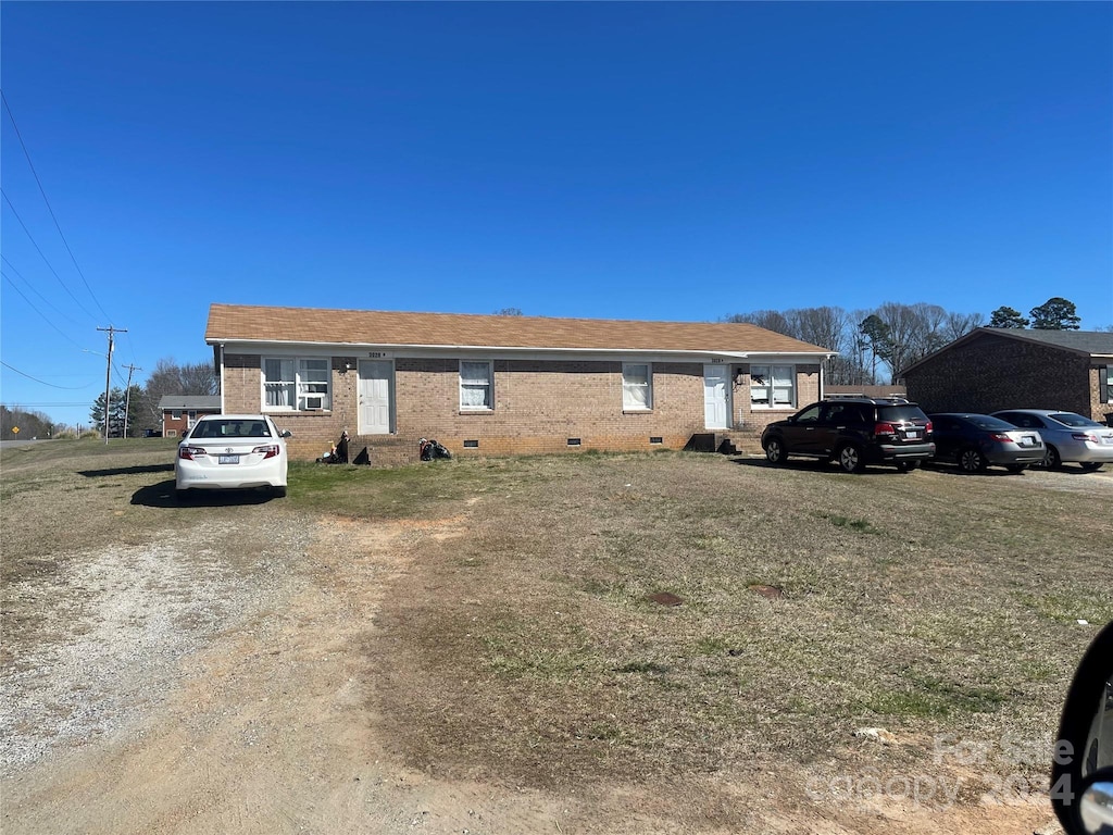 single story home with brick siding, roof with shingles, and crawl space