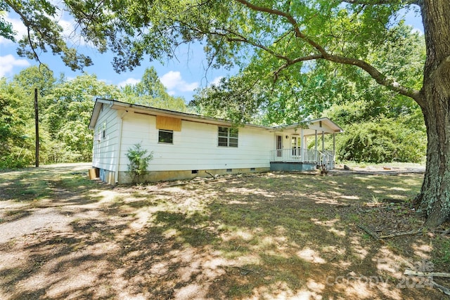 back of house featuring a porch