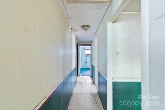 hallway with wood-type flooring