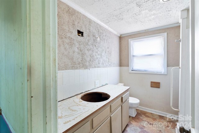 bathroom with a textured ceiling, toilet, backsplash, tile patterned floors, and vanity