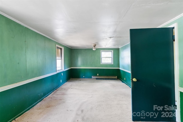 spare room with ceiling fan, crown molding, and baseboard heating