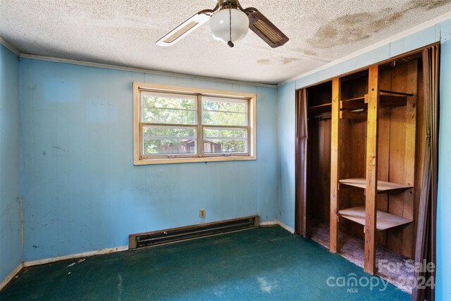 unfurnished bedroom featuring ceiling fan, baseboard heating, carpet flooring, and a textured ceiling