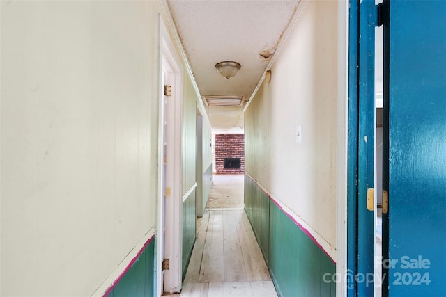 hallway with light hardwood / wood-style floors