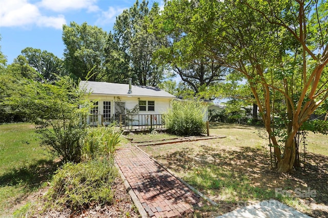 view of yard with french doors and a deck