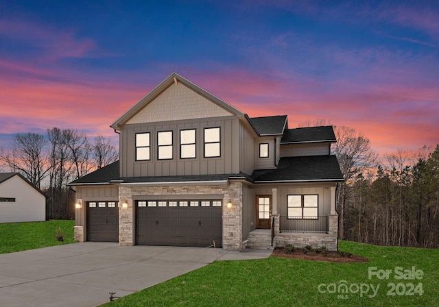 view of front facade with a garage and a yard