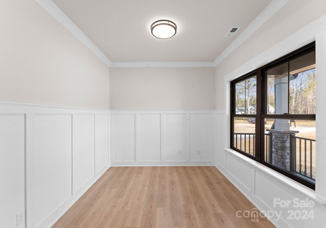 spare room with crown molding and light hardwood / wood-style floors