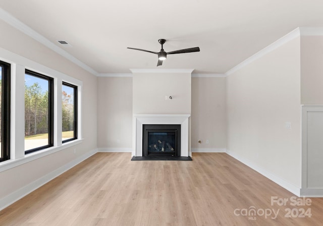 unfurnished living room featuring crown molding, ceiling fan, and light hardwood / wood-style flooring