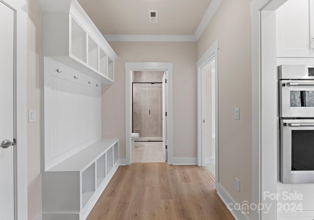 mudroom featuring ornamental molding and light hardwood / wood-style floors