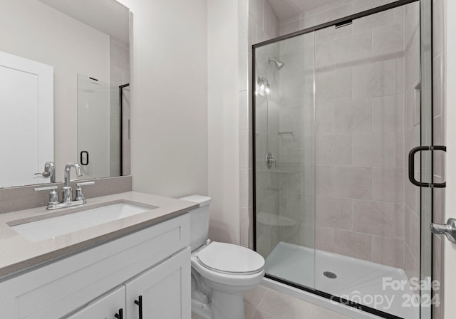 bathroom featuring vanity, tile patterned floors, toilet, and walk in shower