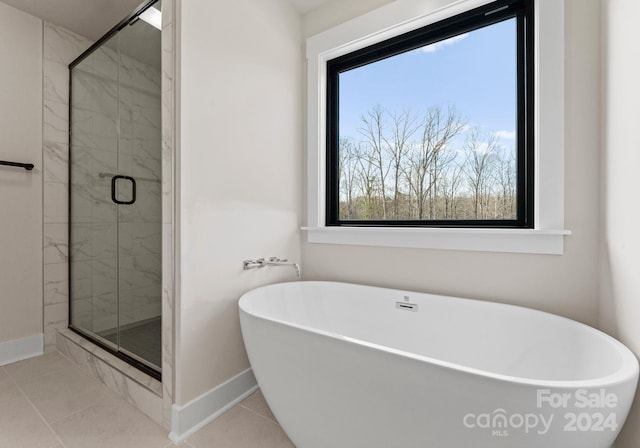 bathroom featuring tile patterned floors and shower with separate bathtub