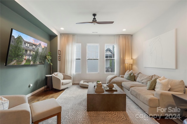 living room with hardwood / wood-style floors and ceiling fan