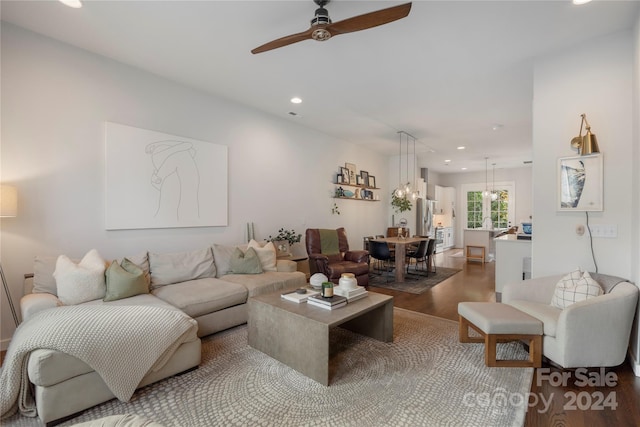 living room with ceiling fan and hardwood / wood-style flooring