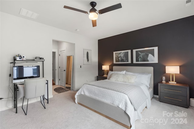 bedroom featuring light colored carpet and ceiling fan