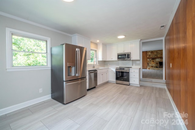 kitchen with white cabinetry, appliances with stainless steel finishes, plenty of natural light, and sink