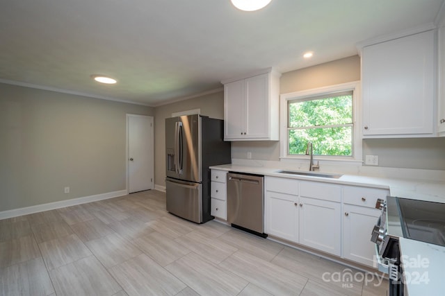 kitchen with appliances with stainless steel finishes, crown molding, sink, and white cabinets