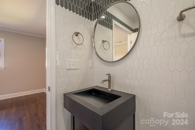 bathroom with ornamental molding, tile walls, hardwood / wood-style flooring, and vanity