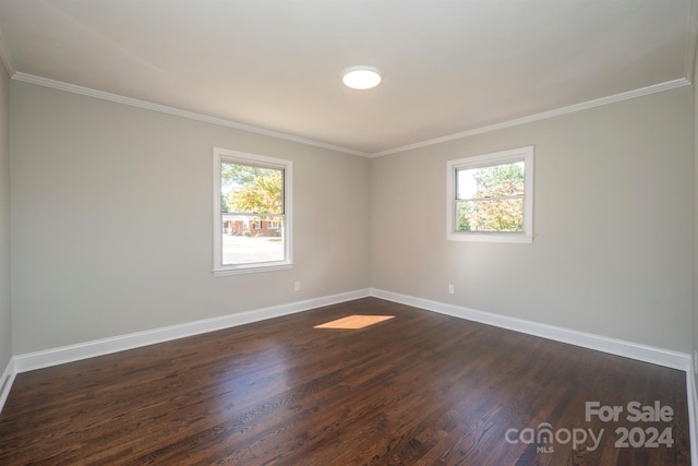 empty room featuring ornamental molding, dark hardwood / wood-style floors, and plenty of natural light