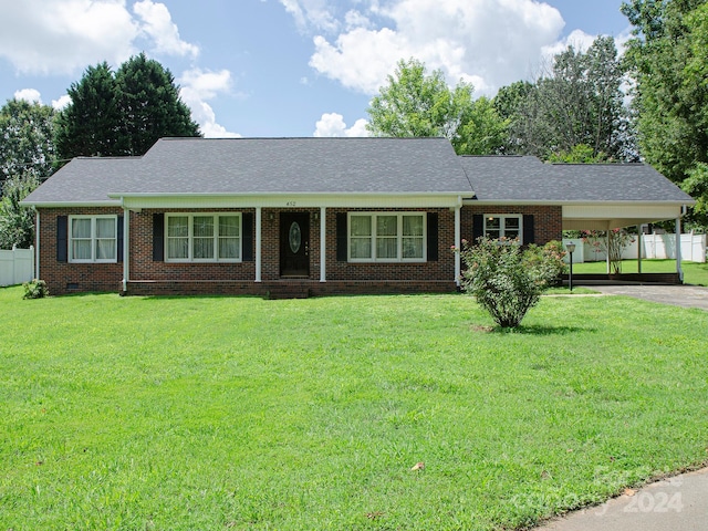 ranch-style house featuring a front lawn and a carport