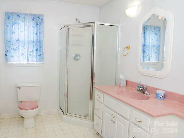 bathroom with walk in shower, vanity, and toilet