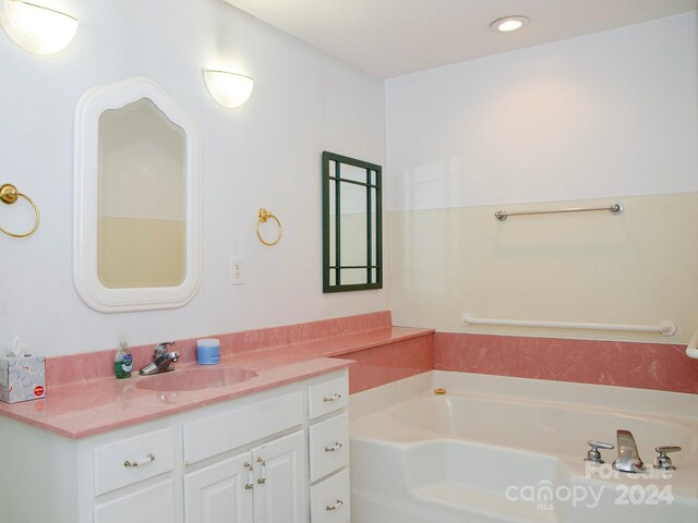 bathroom featuring vanity and a tub to relax in