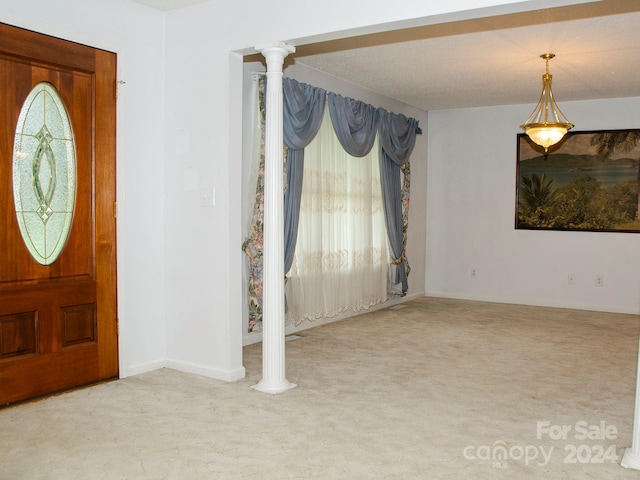 foyer with carpet and ornate columns