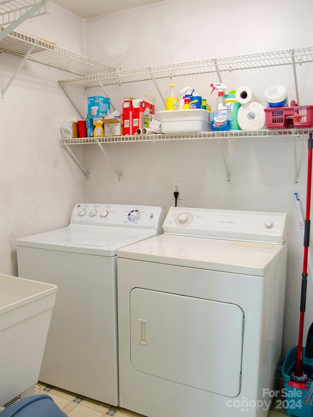 laundry room featuring light tile patterned floors, sink, and washer and dryer