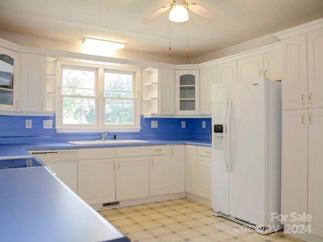 kitchen featuring white appliances, light tile patterned flooring, white cabinetry, ceiling fan, and sink