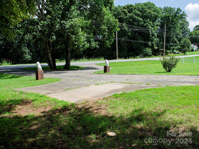 view of home's community with a yard